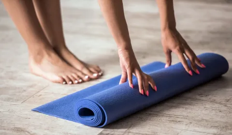 Unrolling yoga mat at pilates class